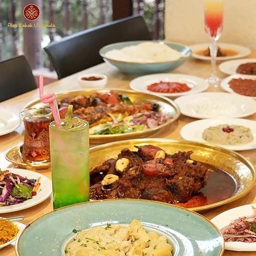 A lavish spread of authentic Turkish cuisine at Alev Kebab Sultanate in Kathmandu, featuring grilled meat platters, hummus, mezze, and signature drinks.